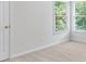 Bedroom featuring neutral walls, carpet, and sun-filled corner windows with views of outside greenery at 4987 Day Lily Nw Way, Acworth, GA 30102