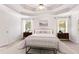 A bedroom with tray ceilings, two windows, and two nightstands at 4987 Day Lily Nw Way, Acworth, GA 30102