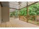 Spacious covered deck with a ceiling fan and spiral staircase, ideal for outdoor relaxation at 4987 Day Lily Nw Way, Acworth, GA 30102