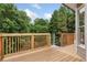 Wooden deck with railings overlooking the wooded backyard, offering a private outdoor space at 4987 Day Lily Nw Way, Acworth, GA 30102