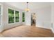 Dining area with hardwood floors, large windows, and view of kitchen at 4987 Day Lily Nw Way, Acworth, GA 30102