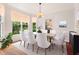 Elegant dining room setup with a modern chandelier, large windows, and neutral decor at 4987 Day Lily Nw Way, Acworth, GA 30102