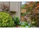 Charming home exterior with a private wood balcony, surrounded by lush greenery and vibrant hydrangea at 4987 Day Lily Nw Way, Acworth, GA 30102
