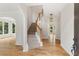 Bright foyer featuring hardwood floors, staircase, and modern light fixtures at 4987 Day Lily Nw Way, Acworth, GA 30102