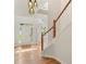 Bright foyer featuring hardwood floors, staircase, and modern light fixtures at 4987 Day Lily Nw Way, Acworth, GA 30102