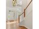 Bright foyer featuring hardwood floors, white wainscoting, and an open staircase at 4987 Day Lily Nw Way, Acworth, GA 30102