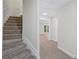 Hallway with stairs leading to a room with natural light through an open door to the backyard at 4987 Day Lily Nw Way, Acworth, GA 30102
