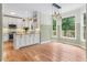 Well-lit kitchen with stone countertops and stainless steel appliances overlooking the dining area at 4987 Day Lily Nw Way, Acworth, GA 30102