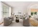 Comfortable living room with ample seating, neutral decor, and large windows at 4987 Day Lily Nw Way, Acworth, GA 30102
