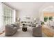 Bright living room with large windows, neutral furniture, and hardwood floors at 4987 Day Lily Nw Way, Acworth, GA 30102