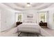 Bright main bedroom with tray ceilings, neutral décor, and large windows at 4987 Day Lily Nw Way, Acworth, GA 30102