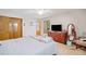 Carpeted bedroom features a double bed, a dresser, a television, and ample closet space at 592 Ferry Creek Ct, Acworth, GA 30102