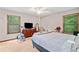 Comfortable bedroom featuring carpet, a ceiling fan, two windows, and a double bed at 592 Ferry Creek Ct, Acworth, GA 30102