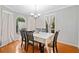 Cozy dining room with wood floors, a chandelier, and natural light from large windows at 592 Ferry Creek Ct, Acworth, GA 30102