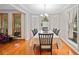 Bright dining room featuring wood floors, a chandelier, and ample seating for Gathering gatherings at 592 Ferry Creek Ct, Acworth, GA 30102