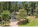 Scenic view of this charming home with a lush green lawn and mature trees creating a peaceful and private setting at 592 Ferry Creek Ct, Acworth, GA 30102
