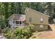 Charming home with a covered porch nestled among lush greenery and mature trees at 592 Ferry Creek Ct, Acworth, GA 30102