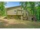Back yard features a two story home and grassy yard at 592 Ferry Creek Ct, Acworth, GA 30102