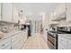 Modern kitchen with stainless steel appliances, granite countertops, and white cabinetry at 592 Ferry Creek Ct, Acworth, GA 30102