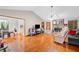 Spacious living room featuring a stone fireplace, hardwood floors, and an open layout at 592 Ferry Creek Ct, Acworth, GA 30102