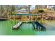 Lakefront home with a private covered dock, providing boat access and a scenic view at 6313 Shoreland Cir, Buford, GA 30518