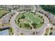 Aerial view showcases the meticulously landscaped roundabout featuring walking paths and vibrant greenery at 2870 Prestwood Dr, Cumming, GA 30040