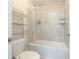 Bathroom features a tiled shower and bathtub combination with metal shelving for storage at 2870 Prestwood Dr, Cumming, GA 30040