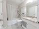 Bright bathroom featuring a shower over the bath, vanity with granite countertop, and tiled walls at 2870 Prestwood Dr, Cumming, GA 30040