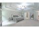 Expansive primary bedroom with elegant tray ceiling, carpet, and seating area at 2870 Prestwood Dr, Cumming, GA 30040