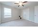 Neutral bedroom features a ceiling fan, a window with blinds, and neutral carpeting at 2870 Prestwood Dr, Cumming, GA 30040