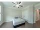 Well-lit bedroom featuring hardwood floors, neutral walls, crown molding, and a ceiling fan at 2870 Prestwood Dr, Cumming, GA 30040