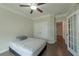 Well-lit bedroom with neutral walls, crown molding, ceiling fan, hardwood floors, and double doors at 2870 Prestwood Dr, Cumming, GA 30040