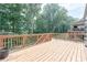 Large wooden deck offers ample space for outdoor entertaining with a view of the wooded backyard at 2870 Prestwood Dr, Cumming, GA 30040