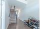 Bright hallway with hardwood floors, staircase, and shoe storage, creating an organized and welcoming space at 2870 Prestwood Dr, Cumming, GA 30040
