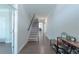 Bright hallway featuring hardwood floors, a staircase, and practical shoe storage, leading to other rooms at 2870 Prestwood Dr, Cumming, GA 30040