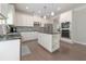 Bright kitchen featuring white cabinets, granite countertops, stainless appliances, and a kitchen island with storage at 2870 Prestwood Dr, Cumming, GA 30040