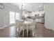 Sunlit eat-in kitchen with white cabinets, stainless steel appliances, hardwood floors, and pendant lighting at 2870 Prestwood Dr, Cumming, GA 30040