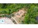 Aerial view of a lush, well-maintained playground with various play structures surrounded by greenery at 2870 Prestwood Dr, Cumming, GA 30040