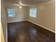 Bedroom featuring hardwood floors, neutral walls, and natural light from windows at 4902 Pine Hill E Ct, Stone Mountain, GA 30088