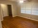 Comfortable bedroom showcasing hardwood floors, ceiling fan, and ample natural light at 4902 Pine Hill E Ct, Stone Mountain, GA 30088