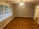 Inviting living room featuring gleaming hardwood floors and natural light from large windows at 4902 Pine Hill E Ct, Stone Mountain, GA 30088