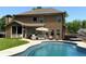Relaxing backyard with a private pool, patio seating, and a hot tub, perfect for outdoor entertaining and leisure at 8340 Nolandwood Ln, Villa Rica, GA 30180