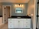 Stylish bathroom features a sleek vanity with a black countertop, ample storage, and modern lighting fixtures at 8340 Nolandwood Ln, Villa Rica, GA 30180
