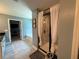 Bright bathroom featuring a glass shower, soaking tub, and black countertops at 8340 Nolandwood Ln, Villa Rica, GA 30180