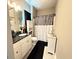 Well-lit bathroom featuring a single vanity and a stylish shower curtain at 8340 Nolandwood Ln, Villa Rica, GA 30180
