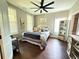 Cozy bedroom features a ceiling fan, large windows, and a comfortable queen-sized bed at 8340 Nolandwood Ln, Villa Rica, GA 30180