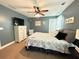 Serene bedroom featuring a cozy bed, ceiling fan, and soft, natural light from the window at 8340 Nolandwood Ln, Villa Rica, GA 30180