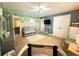 Bedroom featuring a crib, TV and designer accent wall at 8340 Nolandwood Ln, Villa Rica, GA 30180