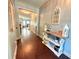 Inviting entryway with hardwood floors, decorative table, and view into living area at 8340 Nolandwood Ln, Villa Rica, GA 30180
