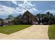 Two-story home with an expansive driveway offers ample parking and features a well-maintained lawn and mature trees at 8340 Nolandwood Ln, Villa Rica, GA 30180